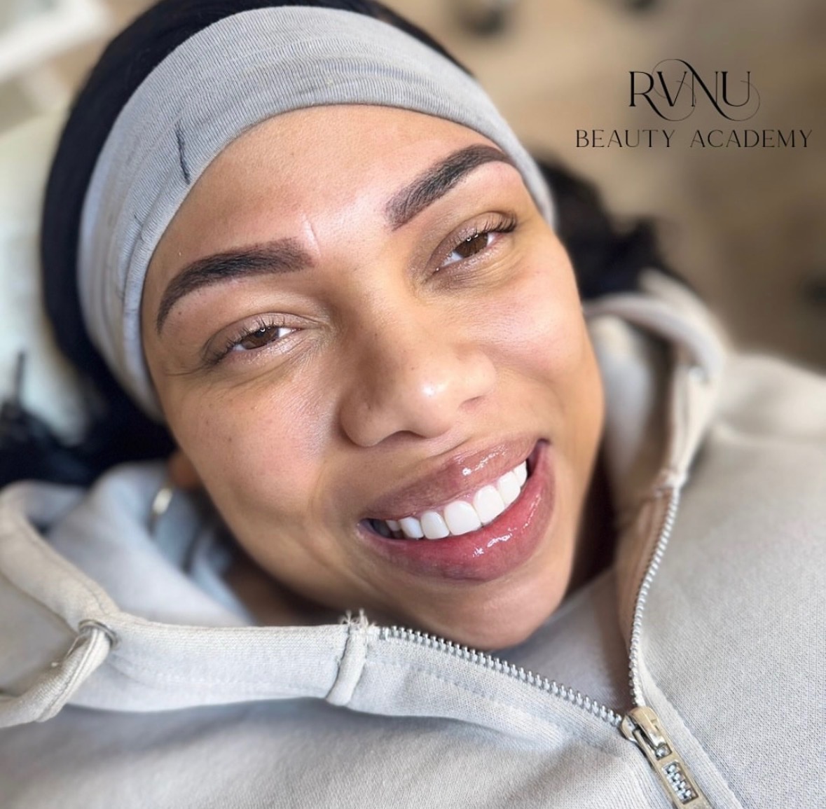 Soft hair-stroke brows and lip blush result on a smiling client