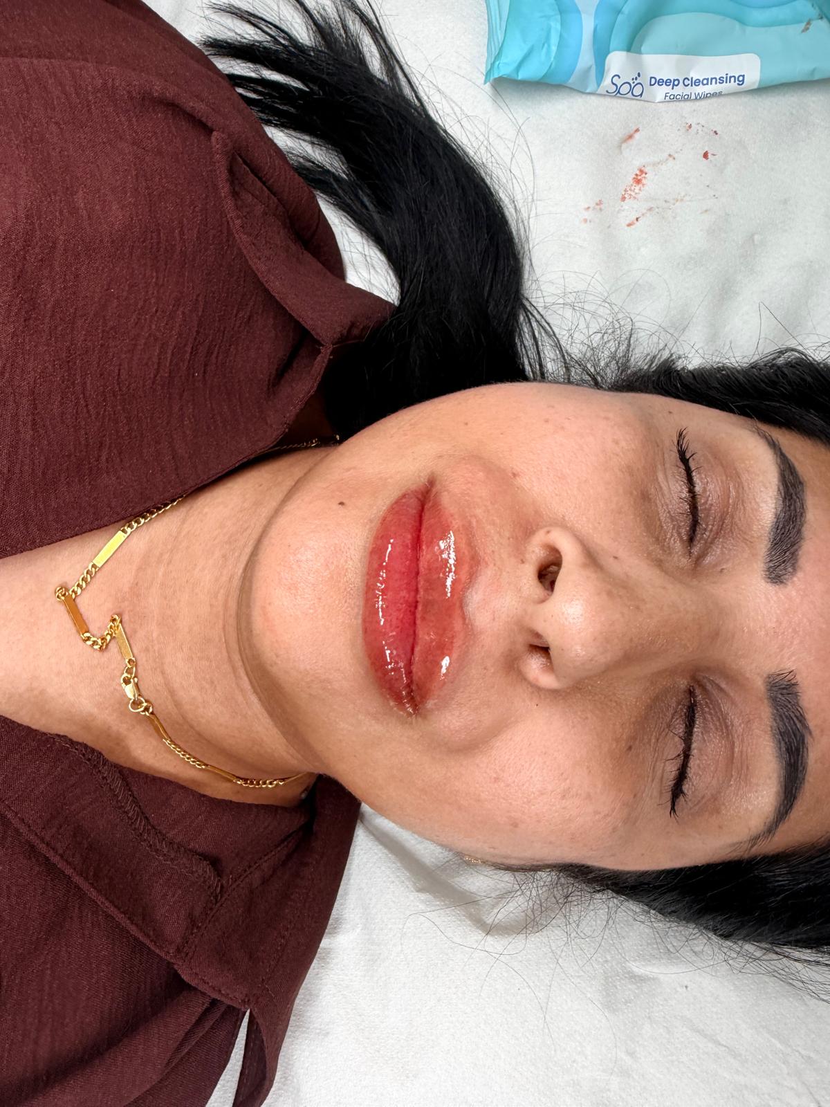 Glossy lip blush and defined brows on a client after treatment