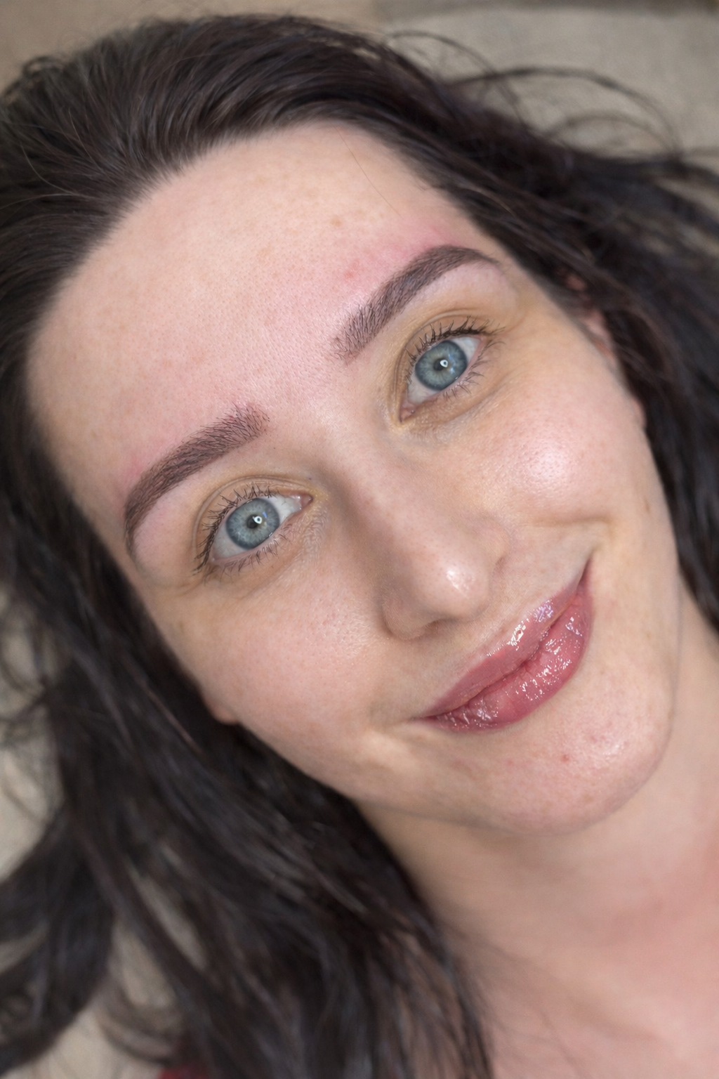 Client with fine hair-stroke brows and lip blush